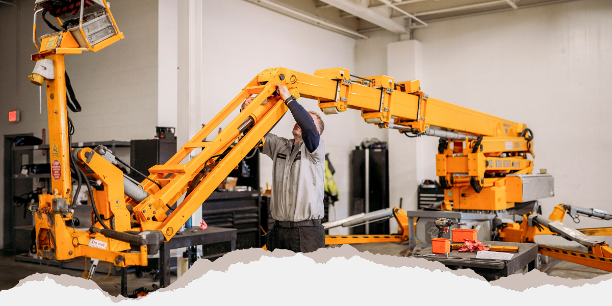 Worker adjusting an aerial lift